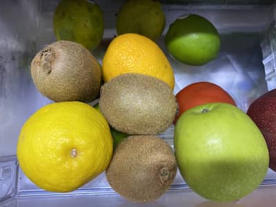 Kiwis in the crisper drawer of a refrigerator.
