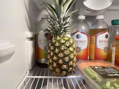 One whole pineapple in a refrigerator.
